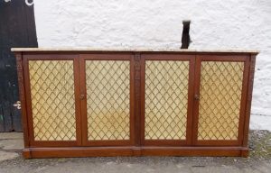 A Regency mahogany stained four door bookcase with marble top