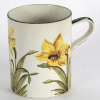 A Wemyss mug painted daffodils within green borders