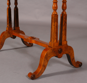 A Regency period walnut and specimen woods rectangular stretcher table.