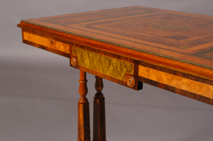 A Regency period walnut and specimen woods rectangular stretcher table.