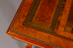 A Regency period walnut and specimen woods rectangular stretcher table.
