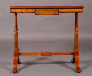 A Regency period walnut and specimen woods rectangular stretcher table.