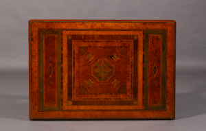 A Regency period walnut and specimen woods rectangular stretcher table.