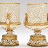 Pair of Grainger & Co. pot pourri vases, each of urn form with bodies, bases and plinths pierced with tracery, female head form handles and gilt detailing with blue enamel jewelled studding, height 21cm, printed factory mark to bases, inscribed "1694"