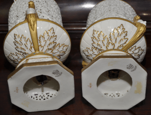Pair of Grainger & Co. pot pourri vases, each of urn form with bodies, bases and plinths pierced with tracery, female head form handles and gilt detailing with blue enamel jewelled studding, height 21cm, printed factory mark to bases, inscribed