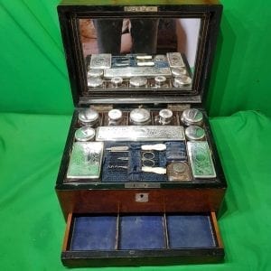 Victorian burr walnut Ladies travelling set. Fitted with silver plated engraved lidded glass bottles and containers. above a pop out lower drawer. Fully fitted and in great condition..