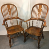 A pair of pad arm Victorian elm Windsor chairs