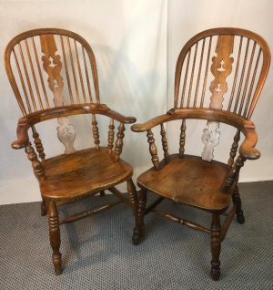 A pair of pad arm Victorian elm Windsor chairs