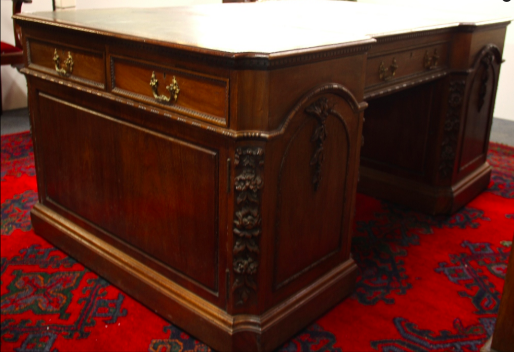 A Victorian carved mahogany partners desk of superior quality