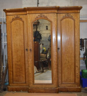 A VICTORIAN BREAKFRONT FIDDLEBACK ASH THREE DOOR MIRROR WARDROBE