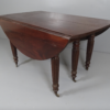 A Georgian extending drop leaf table with three additional leafs