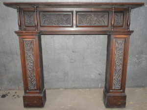A Carved oak Victorian fire surround.