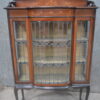 A nice quality Edwardian bow front lead, and stained glass satinwood inlaid display cabinet Raised on carbide legs.