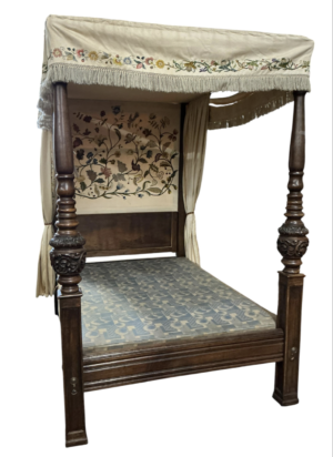 An 18th century style carved oak four poster bed with embroidered drapes, length 211cm, depth 150cm, height 223cm