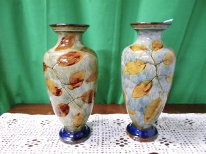 Two similar Doulton autumn leaves vases