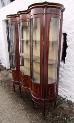 Edwardian serpentine inlaid mahogany display cabinet.